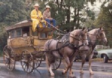 our omnibus being pulled by two horses on a rainy street